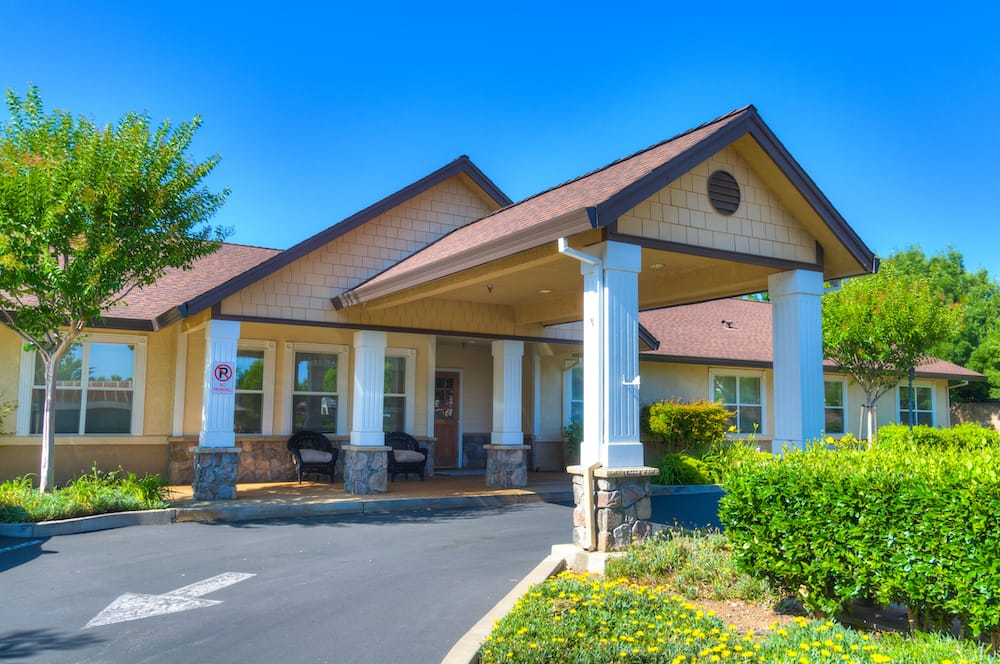 Exterior view of a senior living facility with landscaped gardens