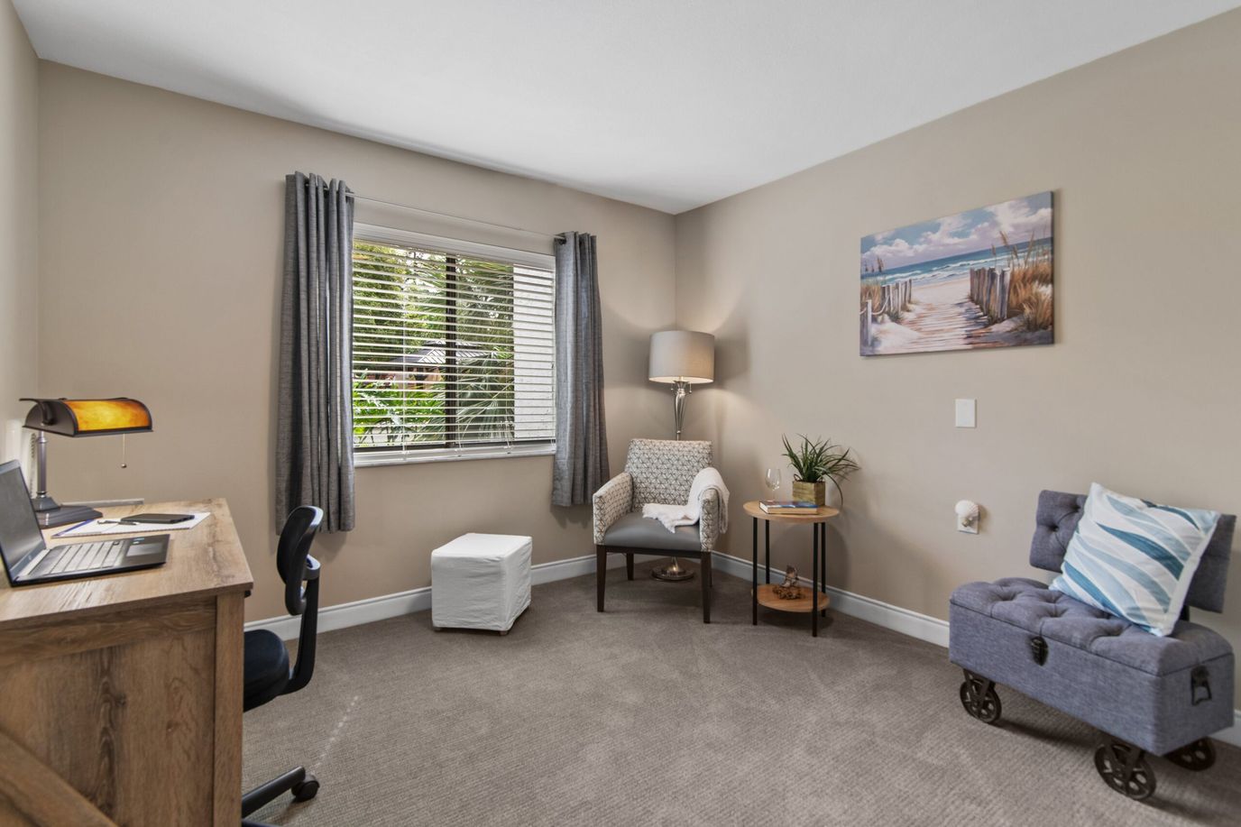 A cozy resident room with a desk and seating area