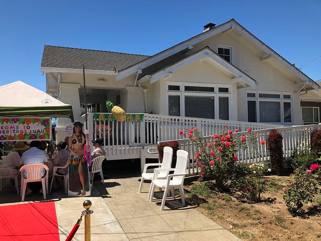 Guests enjoying a luau event at Heritage Residential Care with festive decorations.