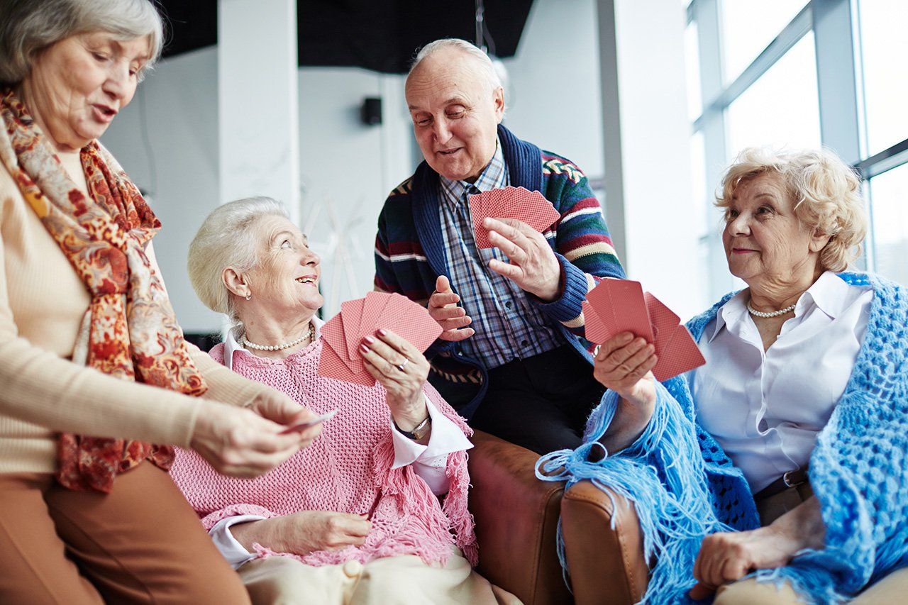Residents enjoying a card game in a cozy lounge