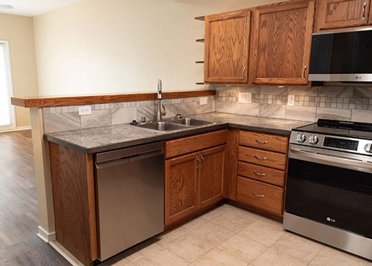 Bright kitchen with modern appliances and wood cabinets