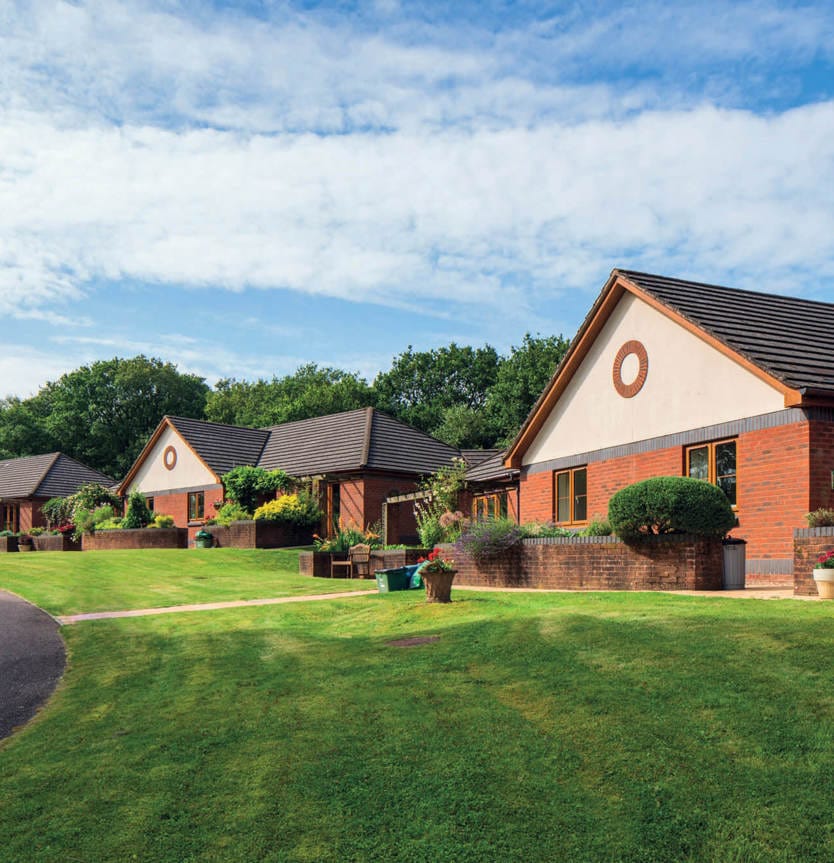 Exterior view of cottages in a landscaped setting