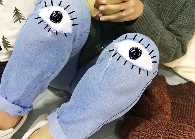 Decorative photo with illustrated eyes on knees