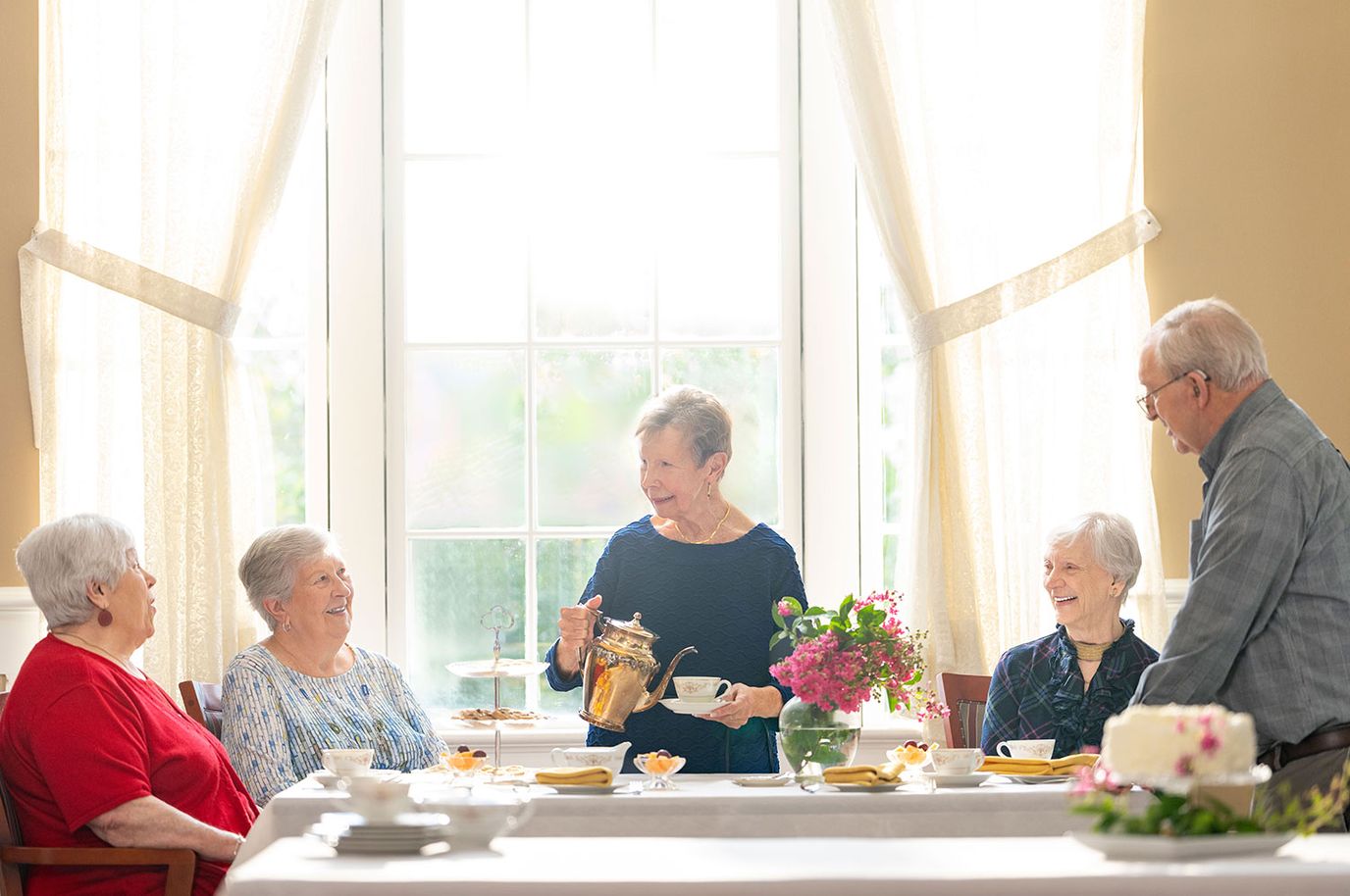 Residents enjoying tea together in a bright common area
