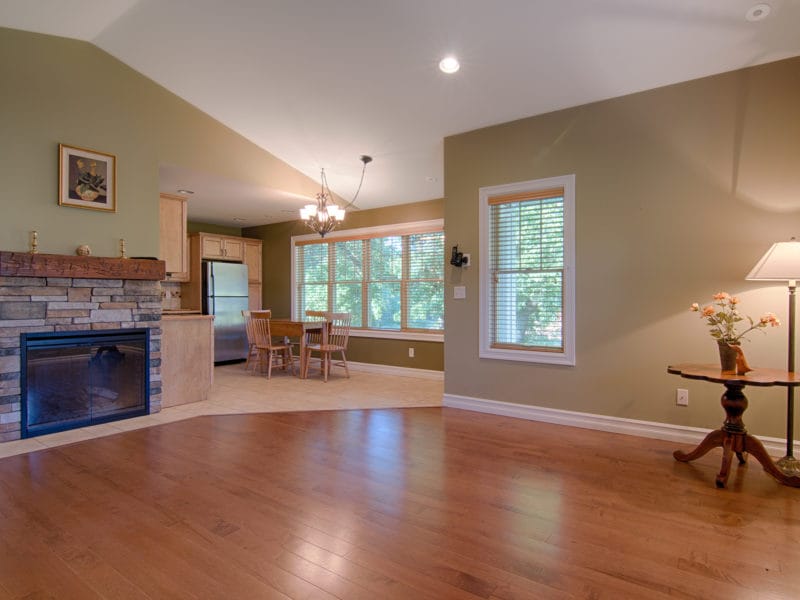 Spacious living room with hardwood floors and large windows