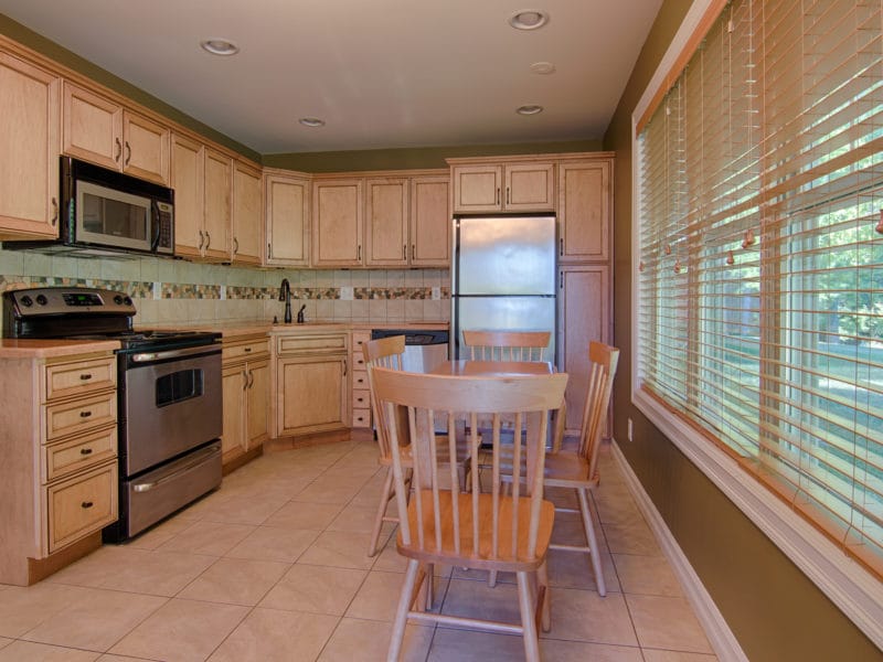 Modern kitchen with wooden cabinets and a dining table