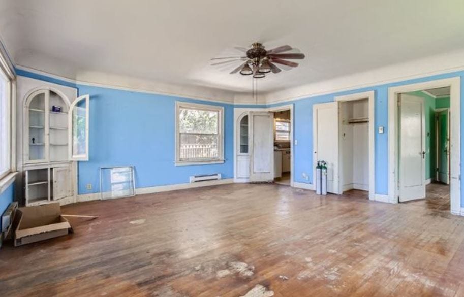 Bright living room with blue walls and wooden floor