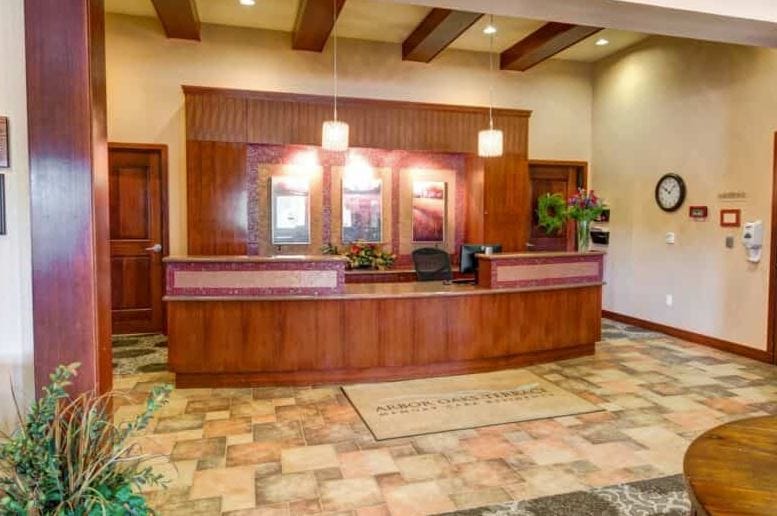 Reception area with wooden desk and decorative plants
