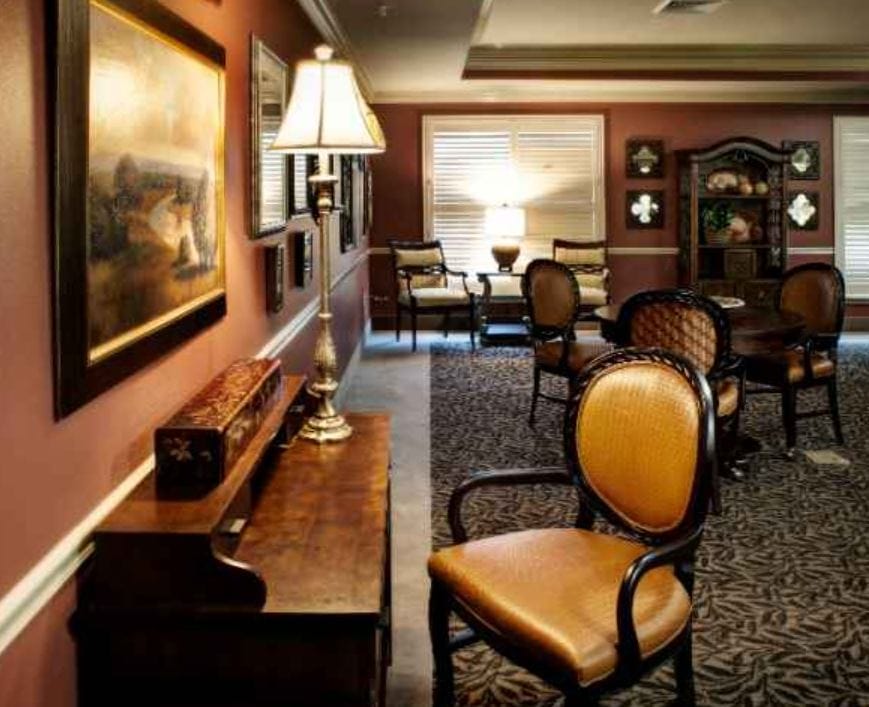 Cozy lounge area with chairs and decorative paintings