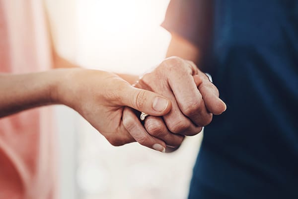 Two hands holding each other warmly.