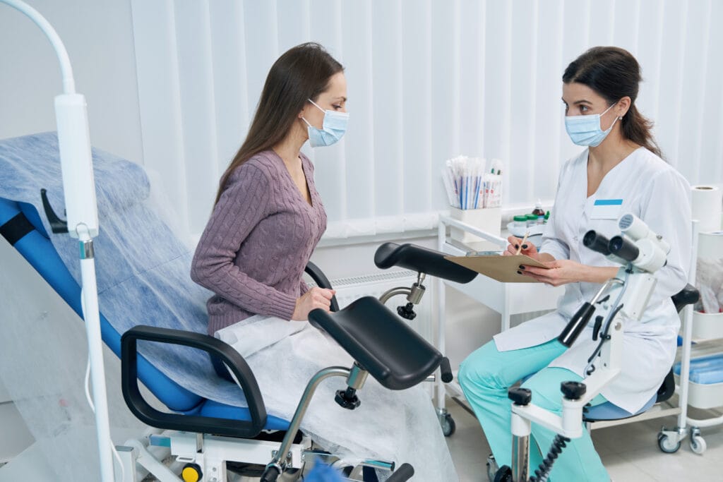 Nurse consulting with a patient in a medical setting.