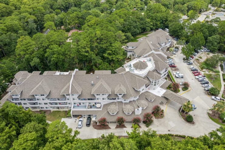 Aerial view of the assisted living facility surrounded by trees.