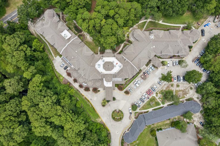 Aerial view of the facility surrounded by trees.