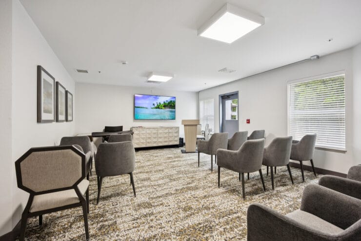 Interior common area with seating and a TV