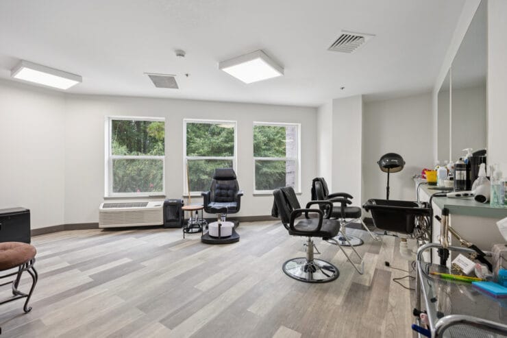 Beauty salon area with styling chairs and mirrors.