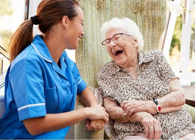 Staff member enjoying a joyful moment with a resident