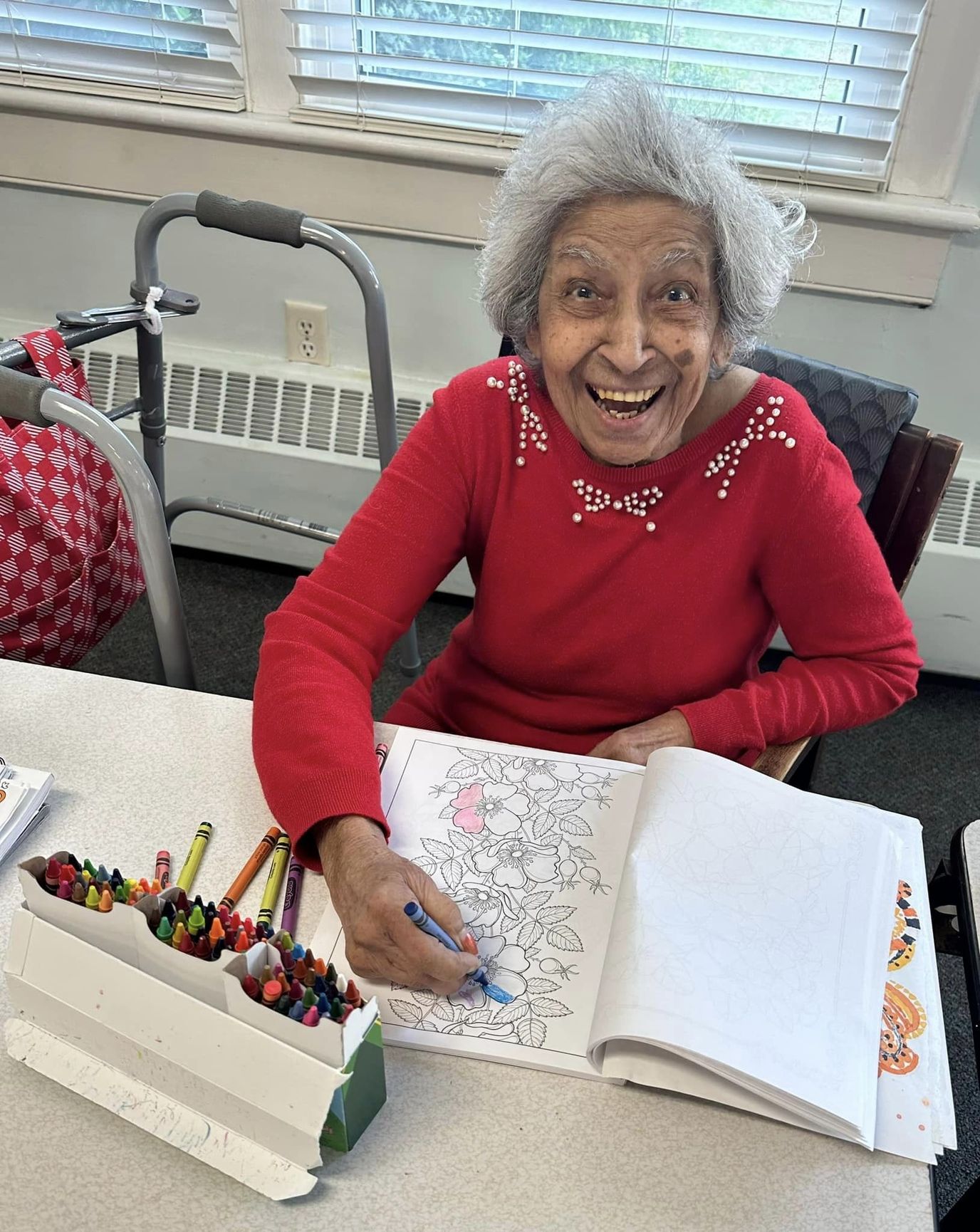 Elderly resident coloring in an activity room