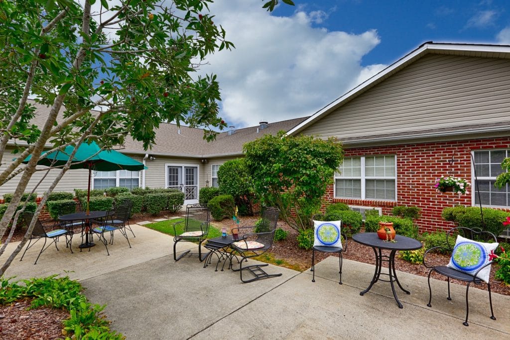 Outdoor seating area with tables and greenery at Columbia Cottage Florence.