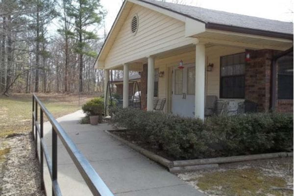 Exterior view of the facility entrance with path and seating