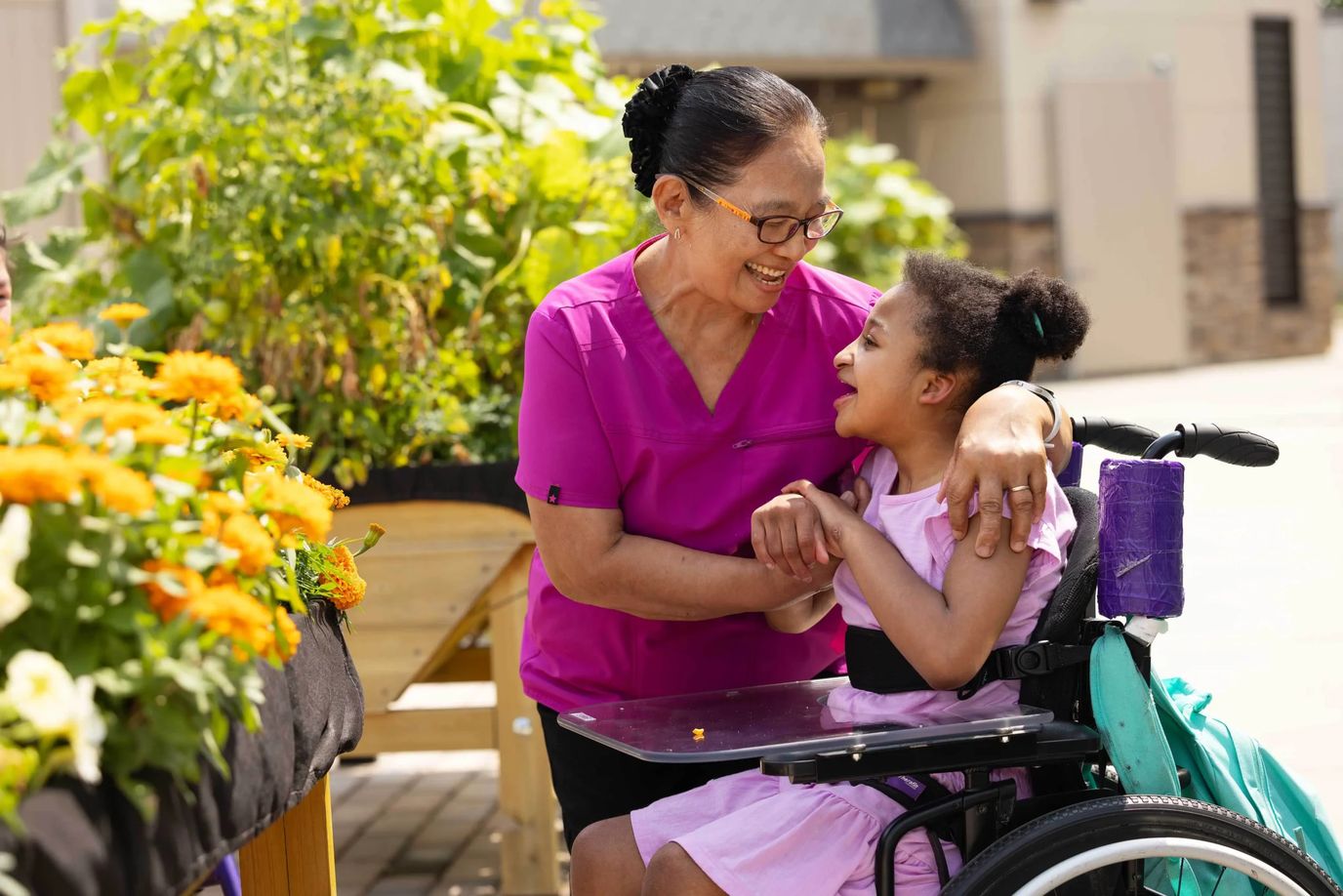 Caregiver and resident enjoying time in the garden