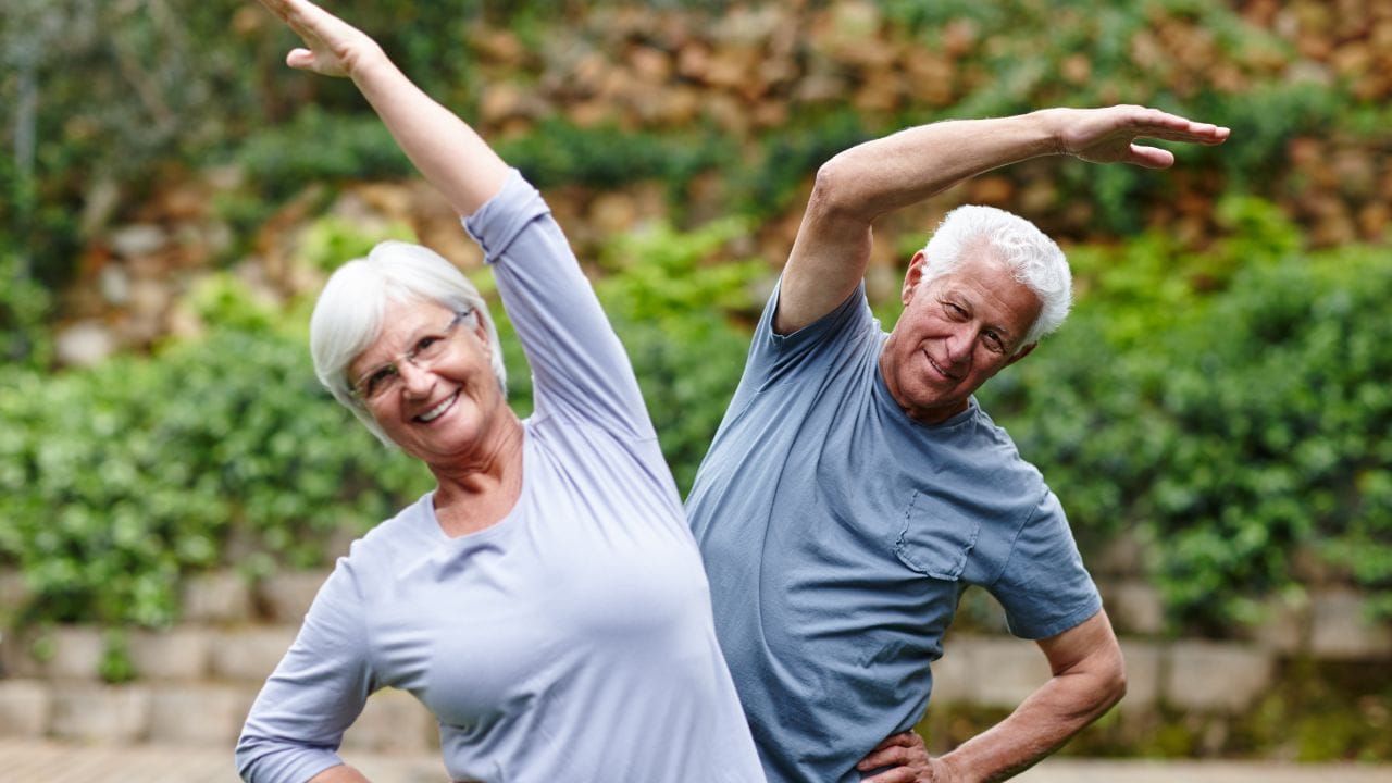 Seniors exercising together outdoors