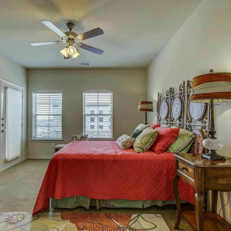 Cozy bedroom interior with a red quilt and stylish decor