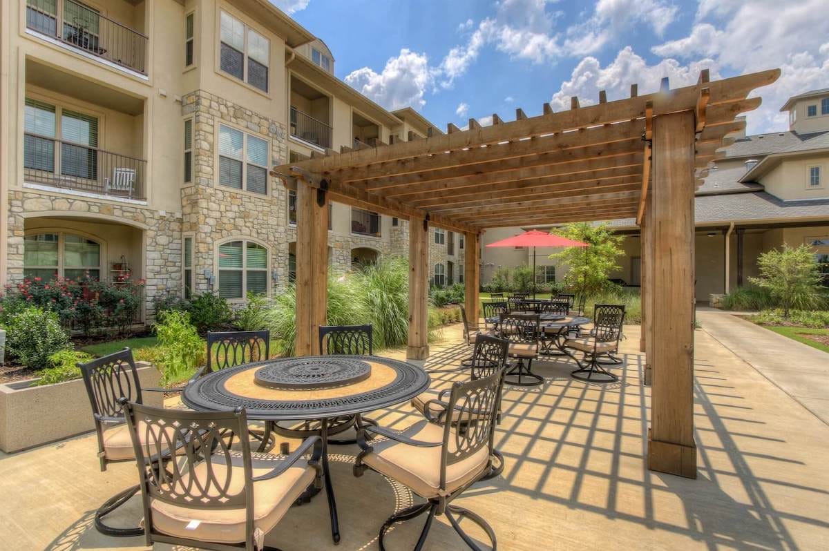 Outdoor seating area with tables and pergola