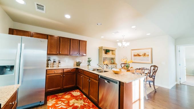 Spacious kitchen with wood cabinetry and stainless steel appliances