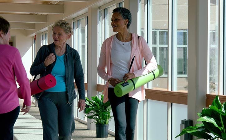 Residents enjoying a wellness activity in a hallway