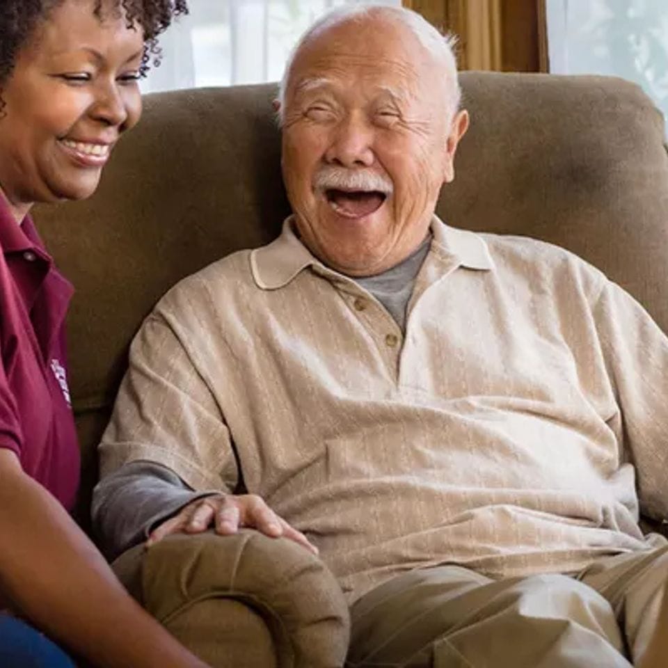 Caregiver and resident sharing a joyful moment