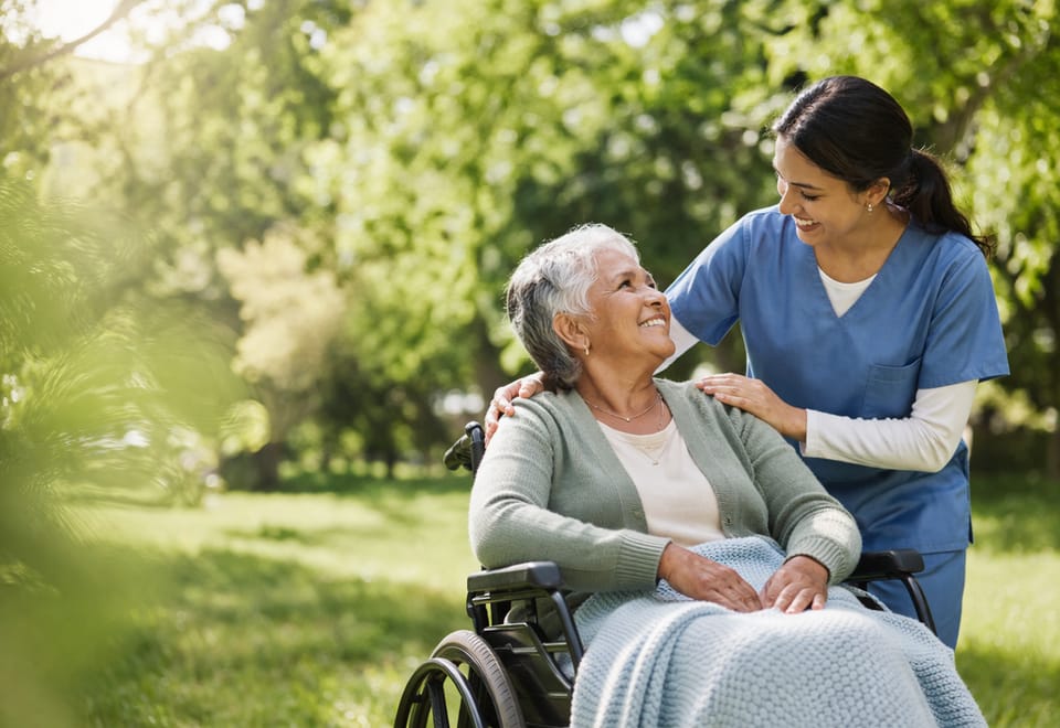 Caregiver assisting a senior in a park
