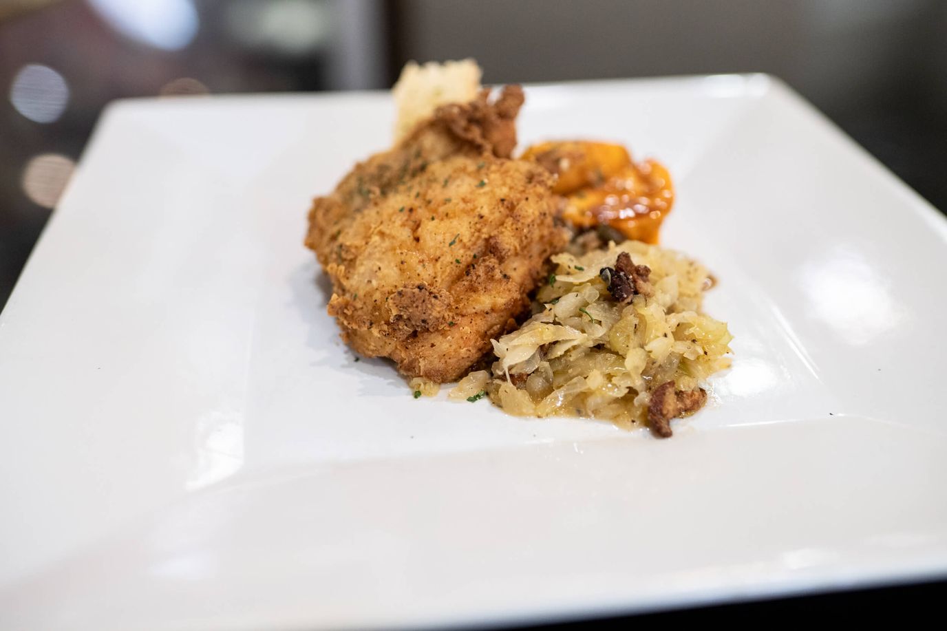 Plate of fried chicken with side dishes
