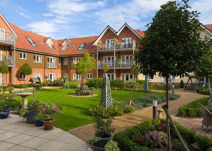 Lush garden area with seating and surrounding buildings