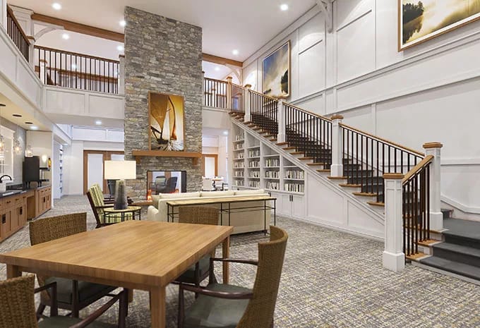 Bright and spacious living area with stone fireplace and seating