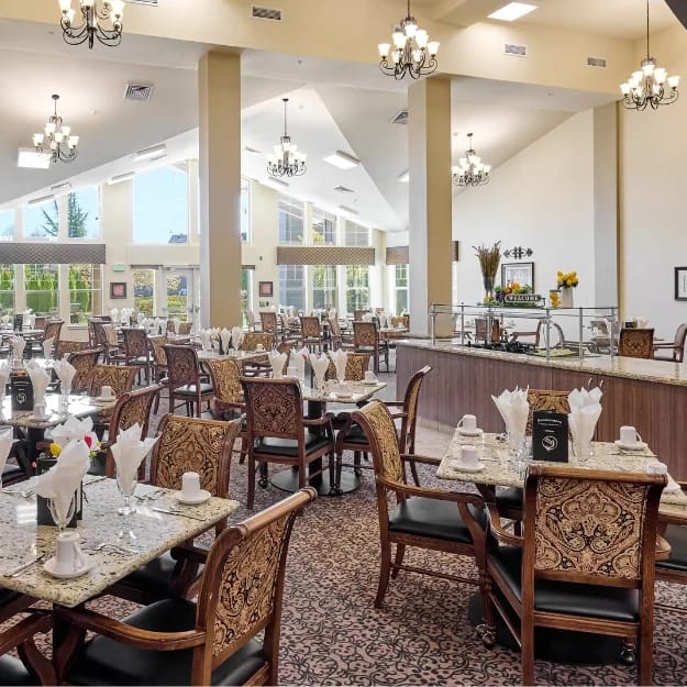 Elegant dining room with tables set at Bonaventure Senior Living