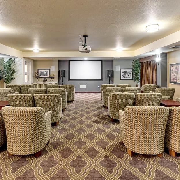 Cozy theater room with rows of chairs and a projection screen