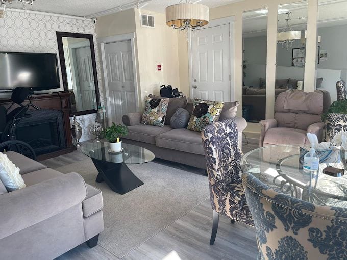 A cozy living room with comfortable seating and a glass coffee table.