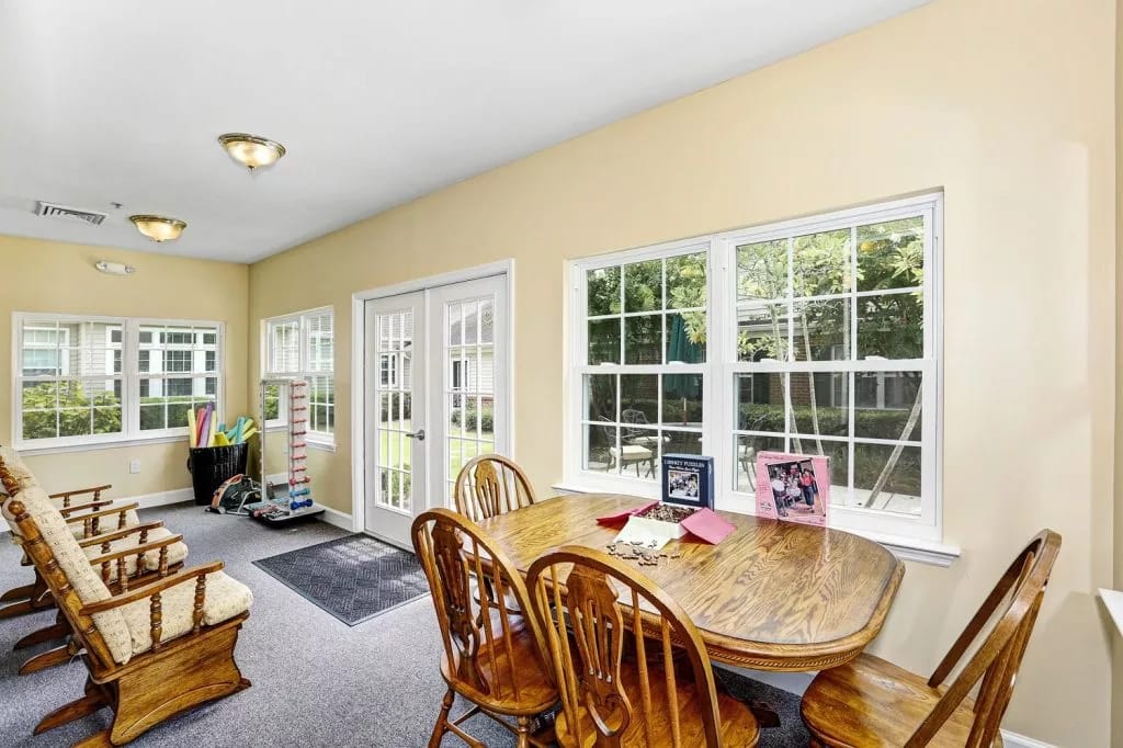 Bright sunroom with seating and dining table