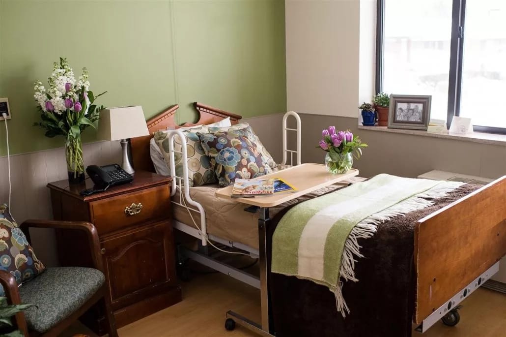 Cozy bedroom with flowers and bedside table