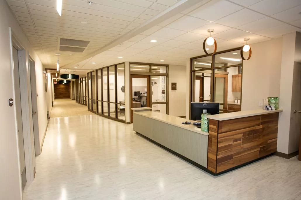 Modern reception desk with a hallway in the background