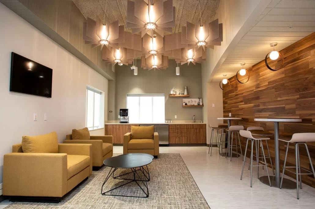 Stylish lounge with yellow chairs and a wooden bar area