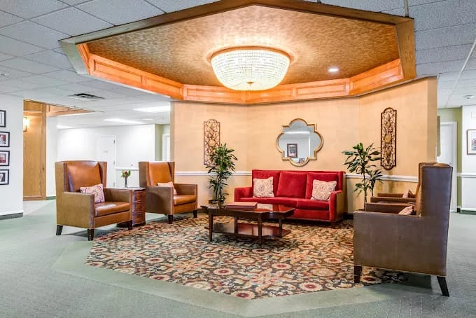 A cozy and inviting lobby with comfortable seating and a chandelier.