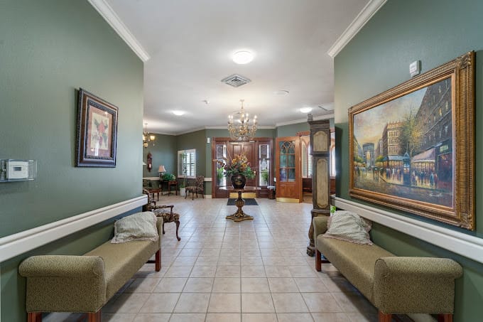 Lobby area with benches, paintings, and chandelier