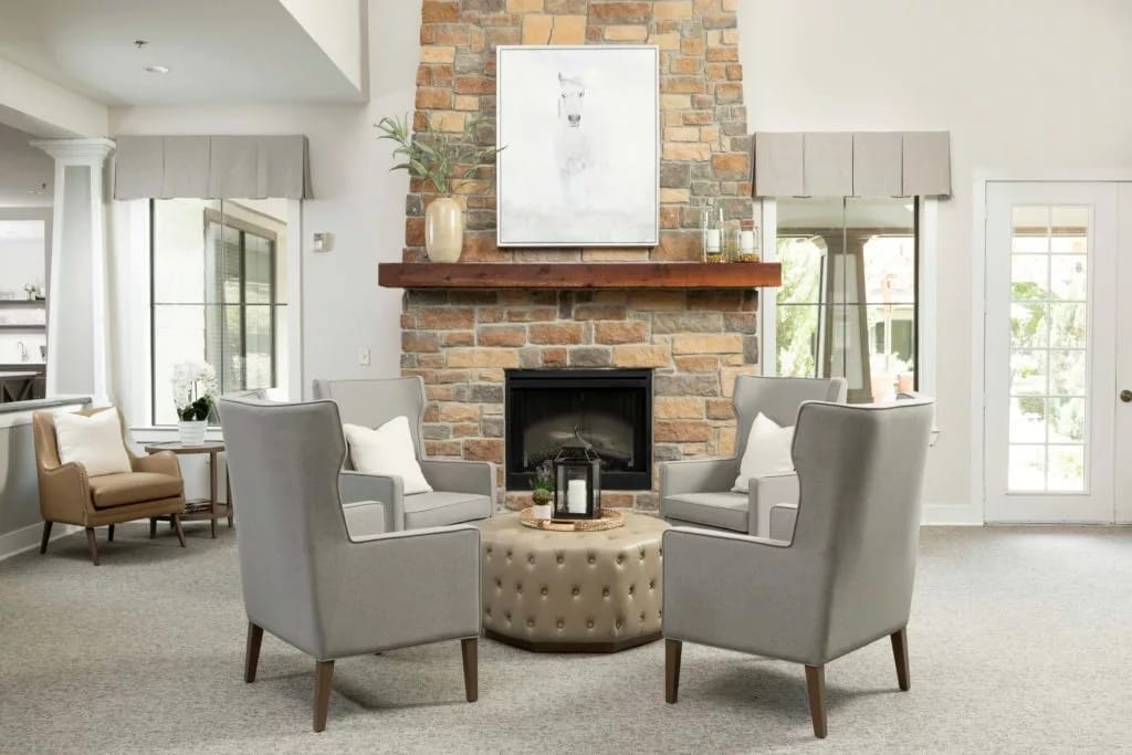Comfortable seating area with a fireplace and large windows.