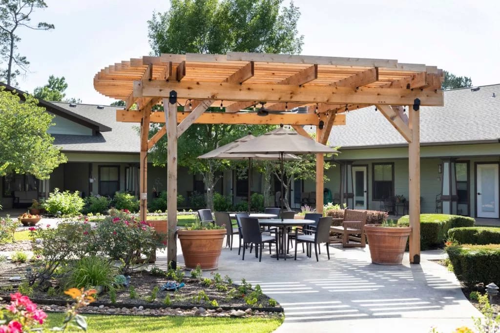 Outdoor patio area with wooden pergola and seating