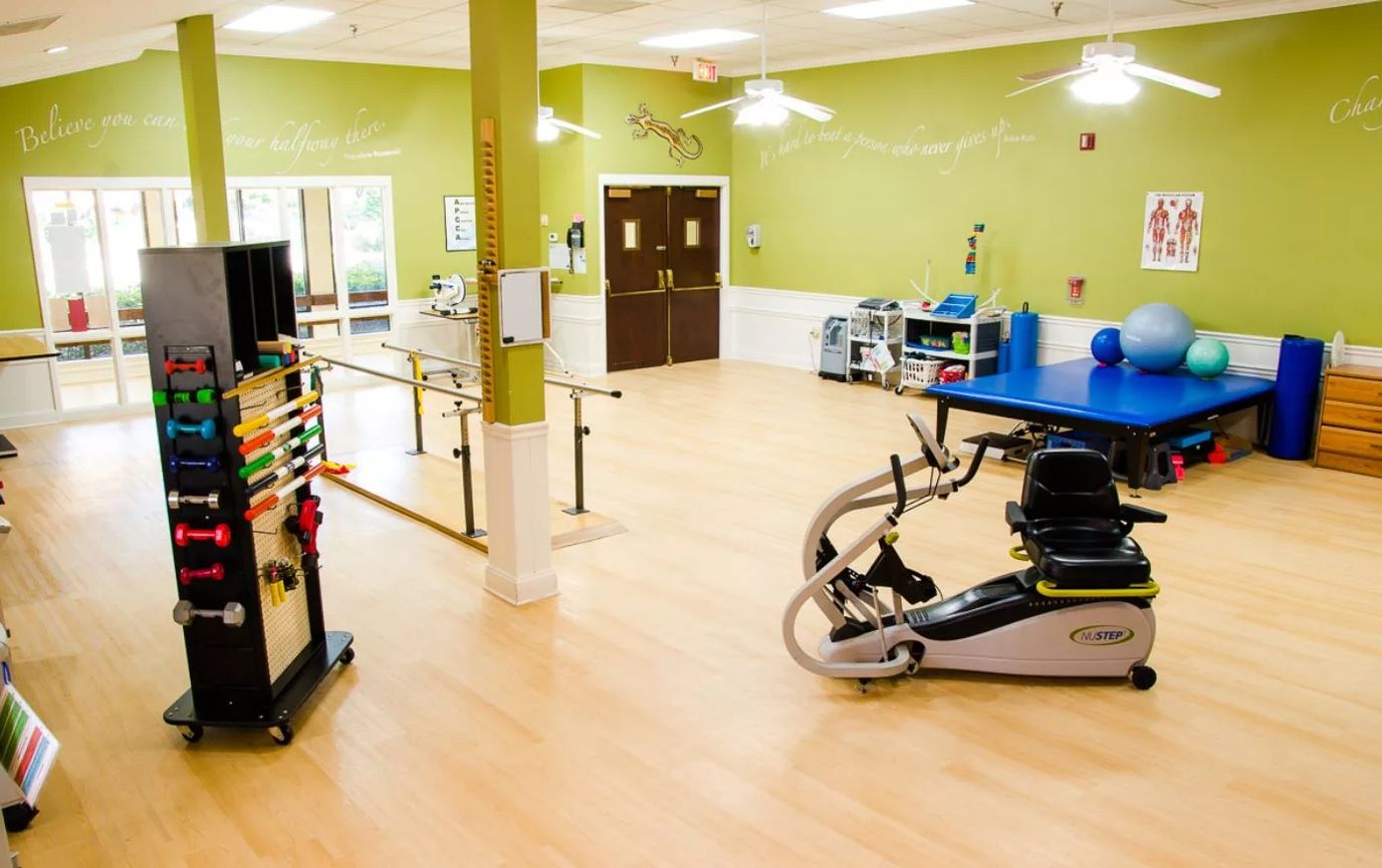Interior view of the therapy room with exercise equipment and therapy aids