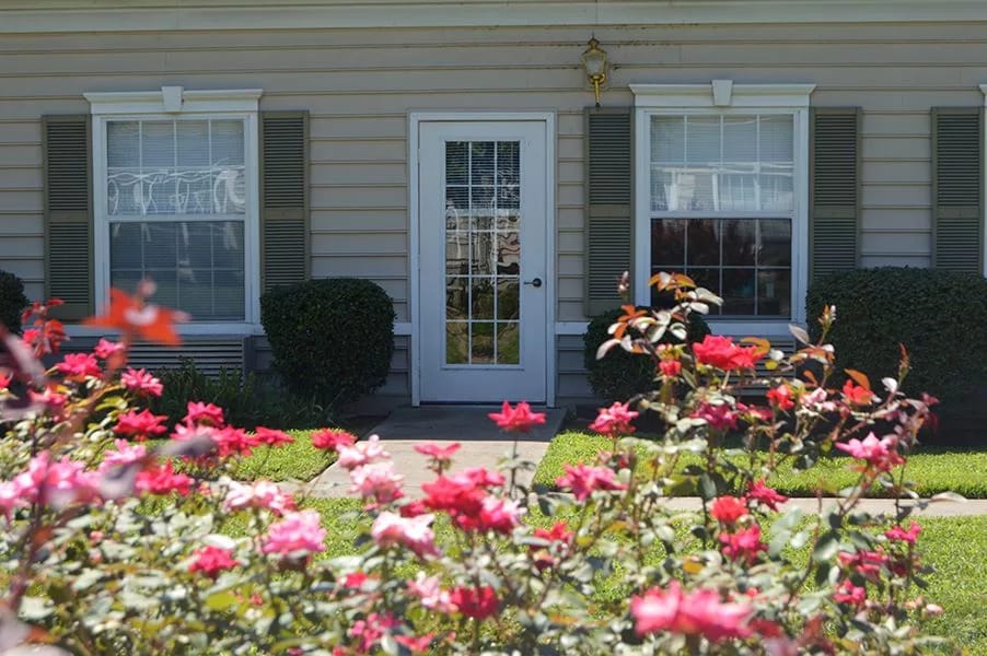 Front entrance of Heritage Place surrounded by blooming roses