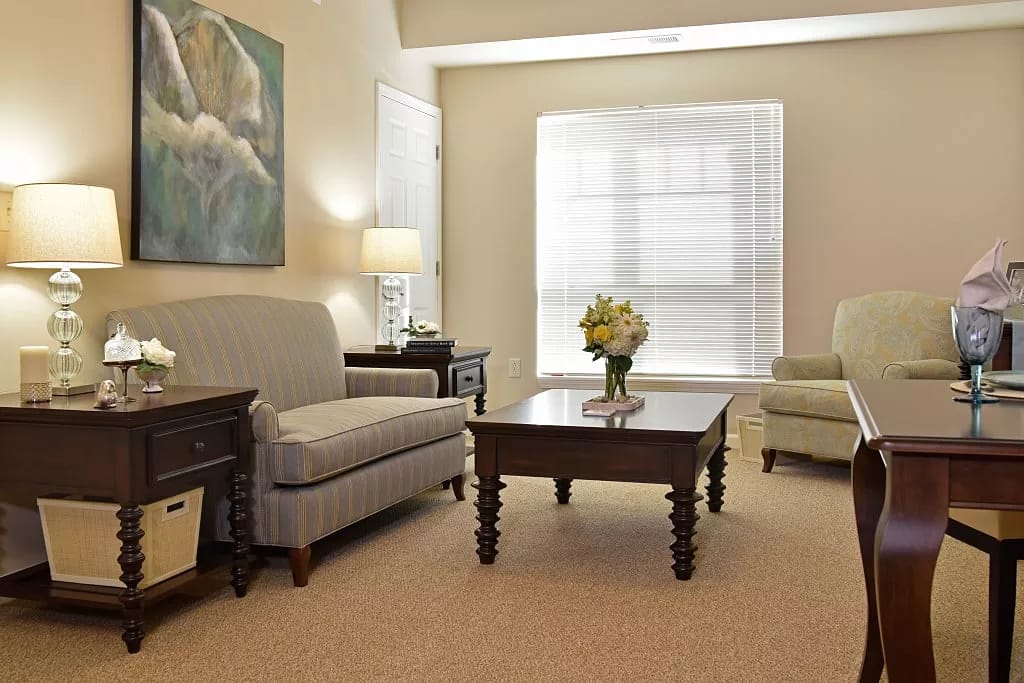 Comfortable living room with a couch, chairs, and a coffee table.