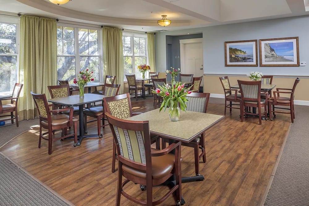 Bright and inviting common area with tables and chairs