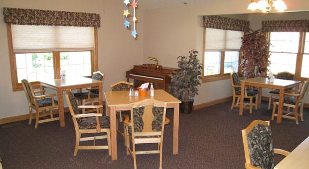 Bright dining area with wooden tables and chairs